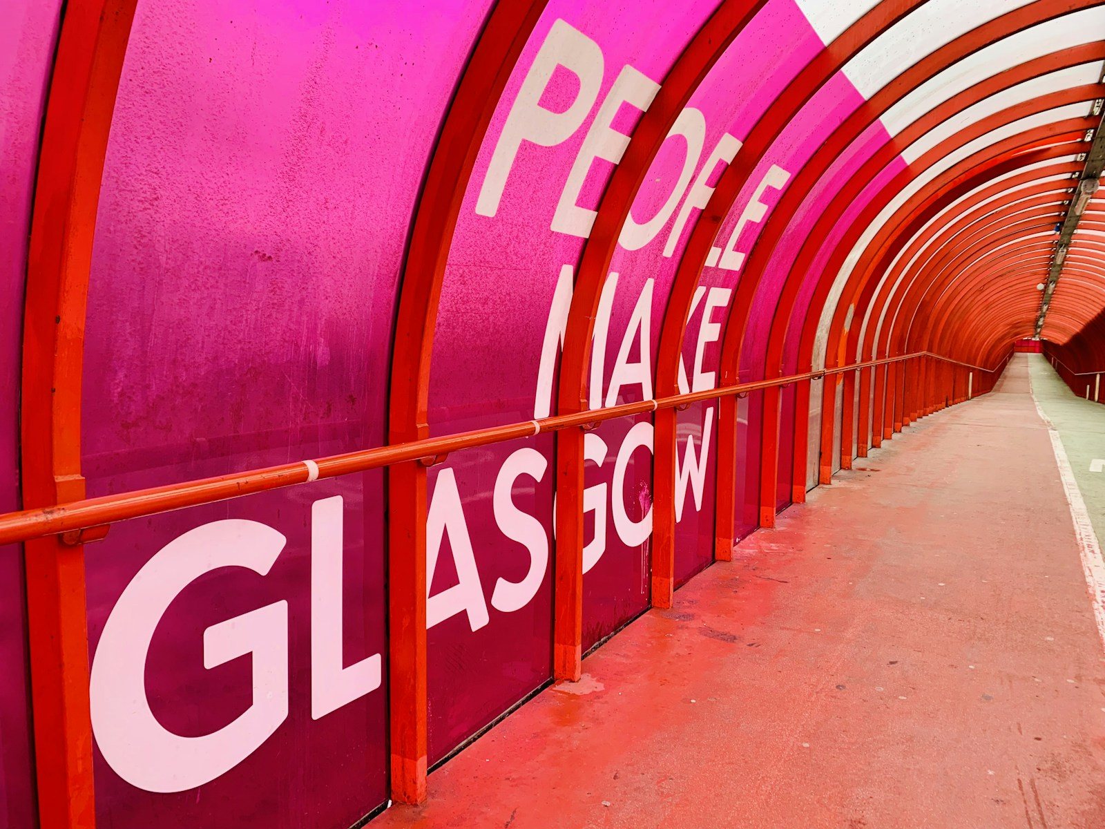 a red and white tunnel with a sign on it